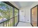 The screened patio features black trim windows and a white door leading to the outside at 11485 Oakhurst Rd # A202, Largo, FL 33774