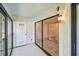 The screened patio features black trim windows and a white door leading into the house at 11485 Oakhurst Rd # A202, Largo, FL 33774