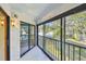 The screened patio has a white tiled floor with a view of the landscape and trees at 11485 Oakhurst Rd # A202, Largo, FL 33774