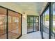 The screened patio has black trim windows with a view of the outdoor landscape at 11485 Oakhurst Rd # A202, Largo, FL 33774