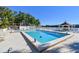Community pool with lake view, surrounded by lounge chairs and a gazebo for relaxing by the water at 11485 Oakhurst Rd # A202, Largo, FL 33774