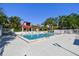 Pool and hot tub with patio furniture located at the community center with lush landscaping at 11485 Oakhurst Rd # A202, Largo, FL 33774