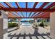 Community pool area with pergola, featuring well-kept landscaping, and glimpses of the serene lake at 11485 Oakhurst Rd # A202, Largo, FL 33774