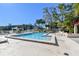 Community pool with lake view, surrounded by lounge chairs and a gazebo for relaxing by the water at 11485 Oakhurst Rd # A202, Largo, FL 33774