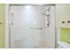 Bathroom shower with sliding doors and an adjustable height shower head and shower accessories shelf at 11485 Oakhurst Rd # A202, Largo, FL 33774