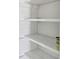 The storage area features empty wooden shelves with white paint at 11485 Oakhurst Rd # A202, Largo, FL 33774