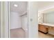 Bright walk-in closet featuring carpeted floors and a built-in shelving system for optimal storage solutions at 11485 Oakhurst Rd # A202, Largo, FL 33774