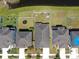 Aerial view of a backyard with a white fence, shed, and trampoline next to a pond at 11872 Thicket Wood Dr, Riverview, FL 33579