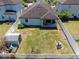 Aerial view of fenced backyard, with patio, shed, fire pit and sparse lawn at 11872 Thicket Wood Dr, Riverview, FL 33579
