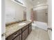 Bathroom featuring granite counters, a tub with shower and tile surround, and tile flooring at 11872 Thicket Wood Dr, Riverview, FL 33579