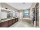 Bright bathroom featuring double sinks, a bathtub, and a separate shower for added convenience at 11872 Thicket Wood Dr, Riverview, FL 33579