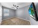This room features carpet, ceiling fan, and a television with beach scene for added appeal and enjoyment at 11872 Thicket Wood Dr, Riverview, FL 33579