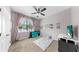 Bright bedroom featuring carpet, ceiling fan, and a window with curtains offers a comfortable and stylish retreat at 11872 Thicket Wood Dr, Riverview, FL 33579