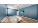 Comfortable bedroom with wall mounted TV, ceiling fan, and plush carpeting at 11872 Thicket Wood Dr, Riverview, FL 33579