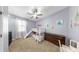 Bedroom featuring bunk beds with slide, a window for natural light, and light purple walls for a relaxing retreat at 11872 Thicket Wood Dr, Riverview, FL 33579