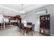 Open concept dining area with dark wood cabinets, seating and stainless appliances at 11872 Thicket Wood Dr, Riverview, FL 33579