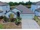 Aerial view of a single-Gathering home with manicured landscaping and a two-car garage at 11872 Thicket Wood Dr, Riverview, FL 33579