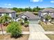 Charming single-story home featuring a well-manicured lawn, mature landscaping, and a two-car garage at 11872 Thicket Wood Dr, Riverview, FL 33579