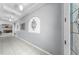Elegant hallway with decorative niches, neutral paint, and tile flooring, leading to the main living areas at 11872 Thicket Wood Dr, Riverview, FL 33579