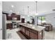 Well-lit kitchen features a large island with stone accents and stainless steel appliances at 11872 Thicket Wood Dr, Riverview, FL 33579