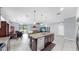 Spacious kitchen with island, granite countertops, stainless steel appliances, and open floor plan at 11872 Thicket Wood Dr, Riverview, FL 33579