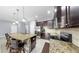 Well-equipped kitchen features stainless steel appliances, granite countertops, and a large island with seating at 11872 Thicket Wood Dr, Riverview, FL 33579