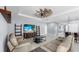 Open-concept living room has a large TV and comfortable seating at 11872 Thicket Wood Dr, Riverview, FL 33579