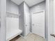 Mud room with ample storage and a bench, providing a convenient transition from outdoors at 11872 Thicket Wood Dr, Riverview, FL 33579