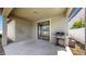 View of the patio with sliding glass doors, grill, and neutral color walls at 11872 Thicket Wood Dr, Riverview, FL 33579