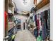Organized walk-in closet with multiple shelves and hanging rods for ample storage space at 11872 Thicket Wood Dr, Riverview, FL 33579