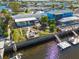 Aerial view of a waterfront home featuring a backyard deck and lush landscaping near the water at 12821 5Th Isle, Hudson, FL 34667