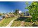 Picturesque backyard featuring a waterfront view, private dock, lush lawn, and mature landscaping at 12821 5Th Isle, Hudson, FL 34667