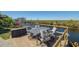 Outdoor deck with waterfront views offering a table and chairs for dining and relaxation at 12821 5Th Isle, Hudson, FL 34667