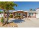 Charming red brick home with a well-manicured front yard and a cozy, inviting entrance at 12821 5Th Isle, Hudson, FL 34667