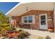 Charming front porch with brick accents and a cozy bench, creating a welcoming entrance at 12821 5Th Isle, Hudson, FL 34667