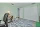 Bright home office featuring natural light, sewing table, and closet at 12821 5Th Isle, Hudson, FL 34667