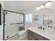 Modern bathroom features glass enclosed shower, sleek fixtures, and updated design at 14537 Cotswolds Dr, Tampa, FL 33626