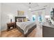 Bedroom featuring a tray ceiling, hardwood floors, and neutral decor at 14537 Cotswolds Dr, Tampa, FL 33626