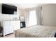 Relaxing bedroom with a white dresser, large mirror, and natural light from the window at 16229 Swan View Cir, Odessa, FL 33556