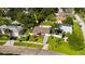 Aerial view of a charming home with a driveway, lawn, trees, and a fenced backyard at 1836 Bayou Grande Ne Blvd, St Petersburg, FL 33703