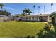 Expansive backyard featuring a lush green lawn and a privacy fence, perfect for outdoor activities and relaxation at 1836 Bayou Grande Ne Blvd, St Petersburg, FL 33703