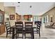 Open-concept dining area with wooden table and chairs seamlessly connects to the kitchen and living room at 18819 Rue Loire St, Lutz, FL 33558