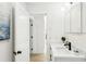 Bright bathroom with a white single sink vanity, black hardware and a modern faucet at 1908 Sutherland W Dr, Palm Harbor, FL 34683