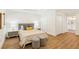 Bright bedroom with shiplap accent wall, wood-look tile floors, and two closets for ample storage at 1908 Sutherland W Dr, Palm Harbor, FL 34683