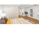 Spacious bedroom with wood-look tile, ensuite bathroom, walk-in closet and private backyard access at 1908 Sutherland W Dr, Palm Harbor, FL 34683