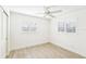 Bright bedroom with ceiling fan, white walls, and shuttered windows allowing ample natural light at 1908 Sutherland W Dr, Palm Harbor, FL 34683