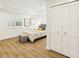 Bedroom with wood-look tile, closet with double doors and stylish decor for a relaxing atmosphere at 1908 Sutherland W Dr, Palm Harbor, FL 34683