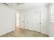 Bedroom featuring white trim, light-colored flooring, and a closet with paneled sliding doors at 1908 Sutherland W Dr, Palm Harbor, FL 34683