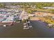 Aerial view showing multiple boats docked at a quaint marina with surrounding waterways and buildings at 1908 Sutherland W Dr, Palm Harbor, FL 34683
