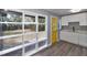 Bright view from the entryway showcasing modern flooring, natural light, and a glimpse of the kitchen at 201 83Rd N Ave, St Petersburg, FL 33702